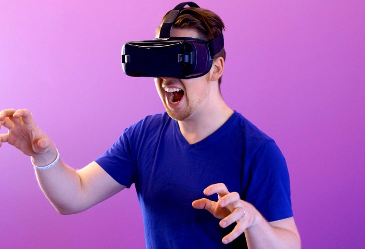 A photo with a person using an virtual reality headset.